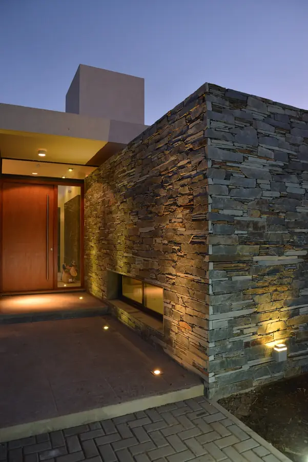 Casa Los Algarrobos — Acceso y muro de piedra